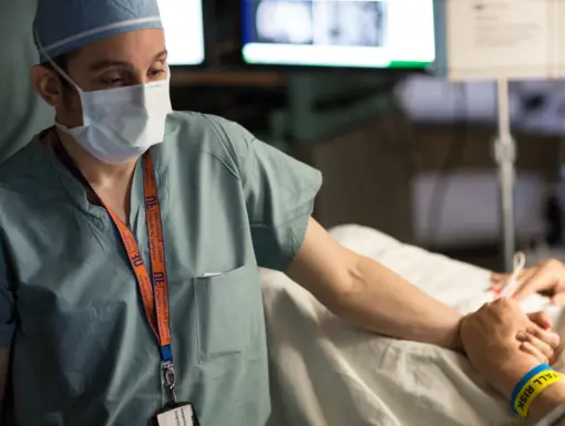 Dr. Michael Okun holding patient's hand