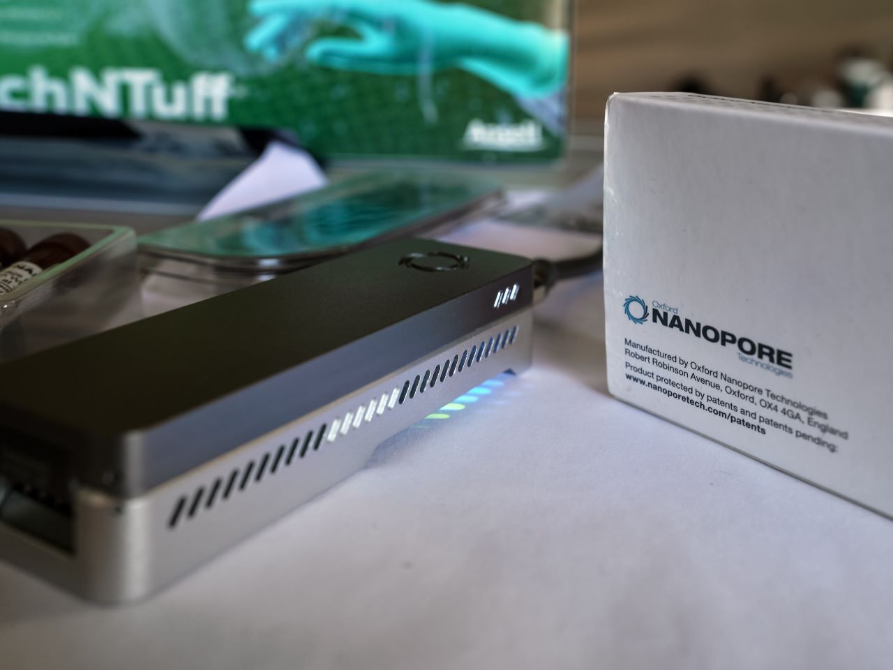 A portable genetic sequencer next to a box that says Nanopore Technologies